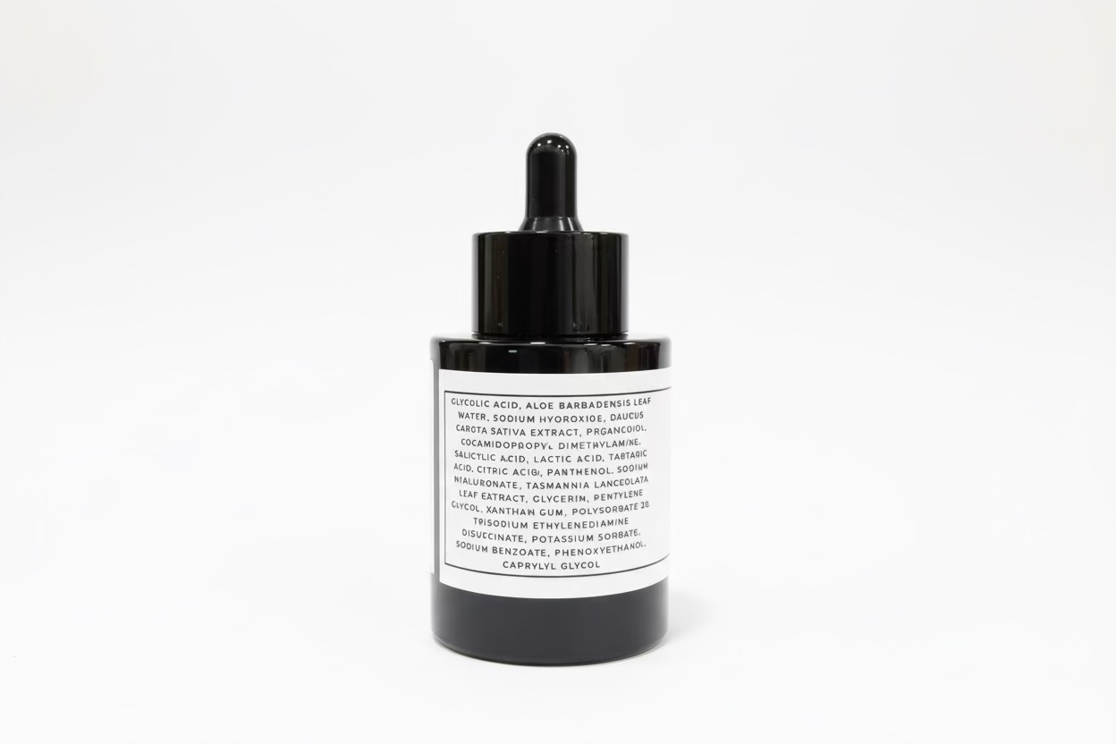 Black dropper bottle with a white label on a white background