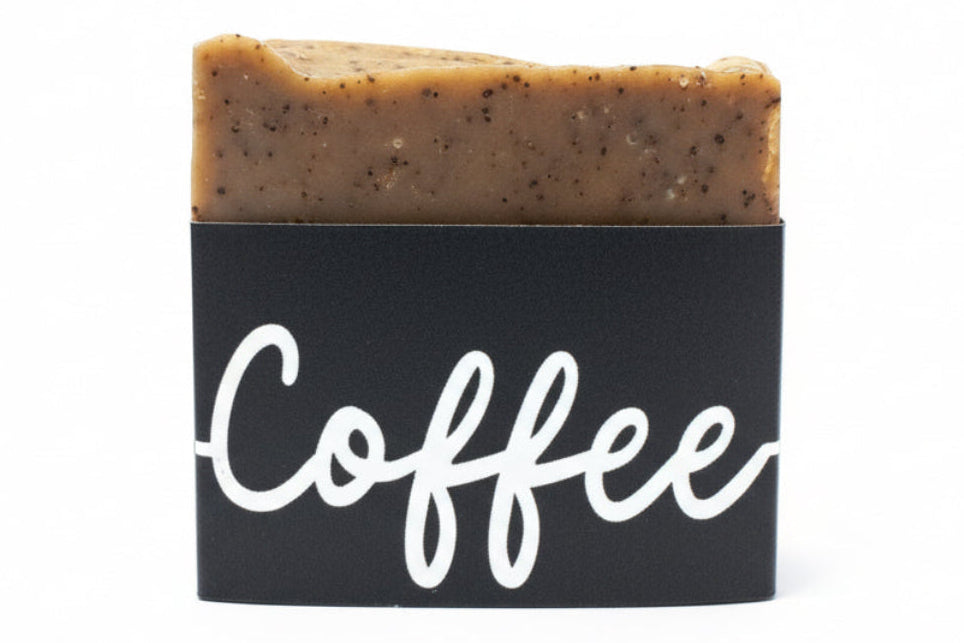 Bar of coffee-scented soap with a black label on a white background