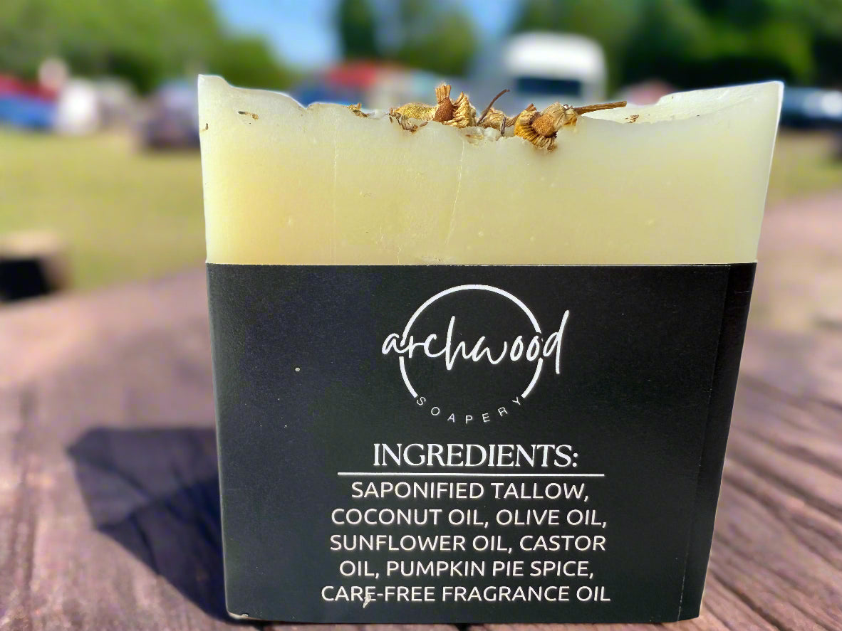 Bar of soap with 'archwood soaper' branding and ingredient list on a wooden surface.