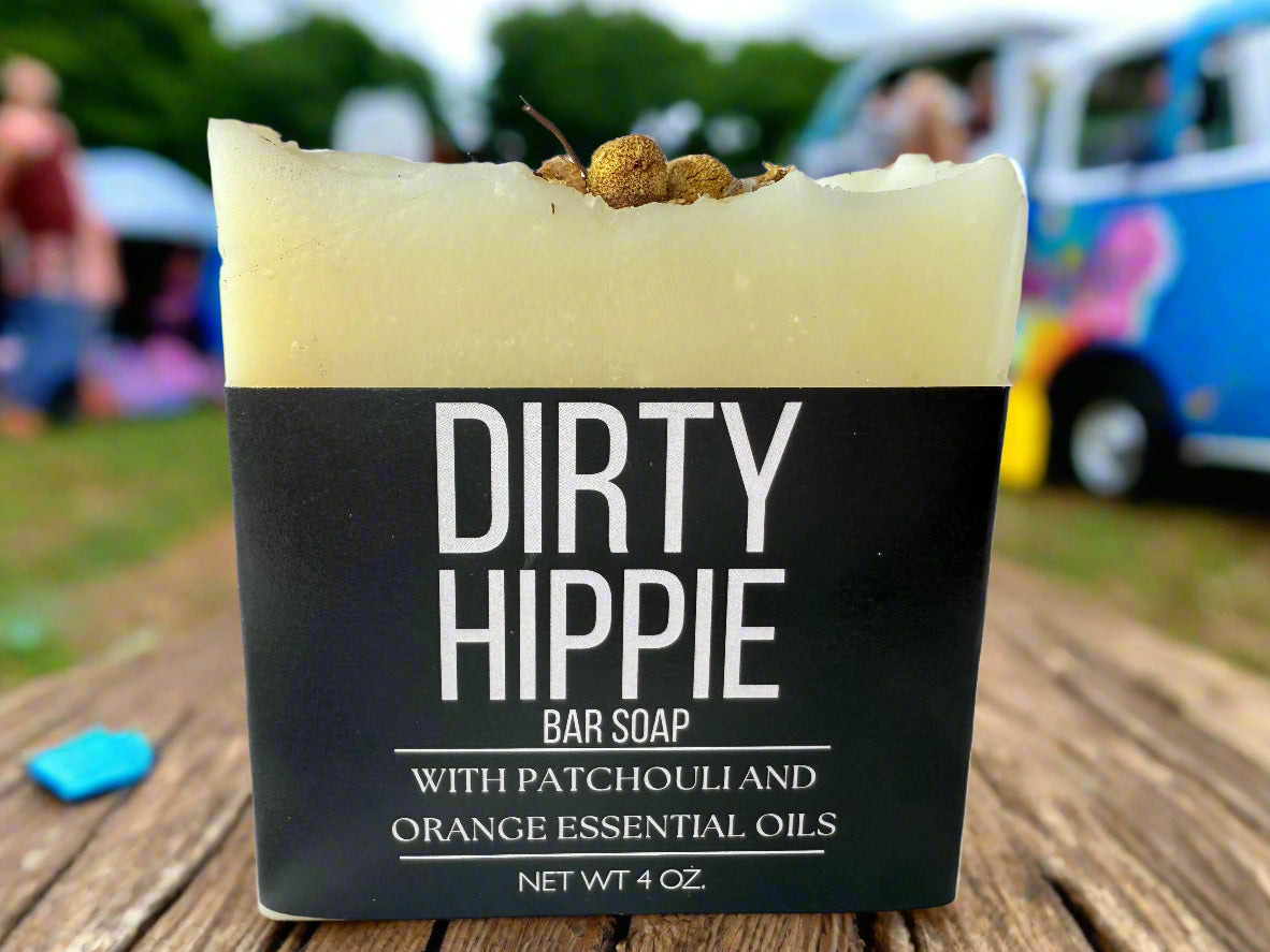 Bar of soap with 'Dirty Hippie' packaging on a wooden surface outdoors.