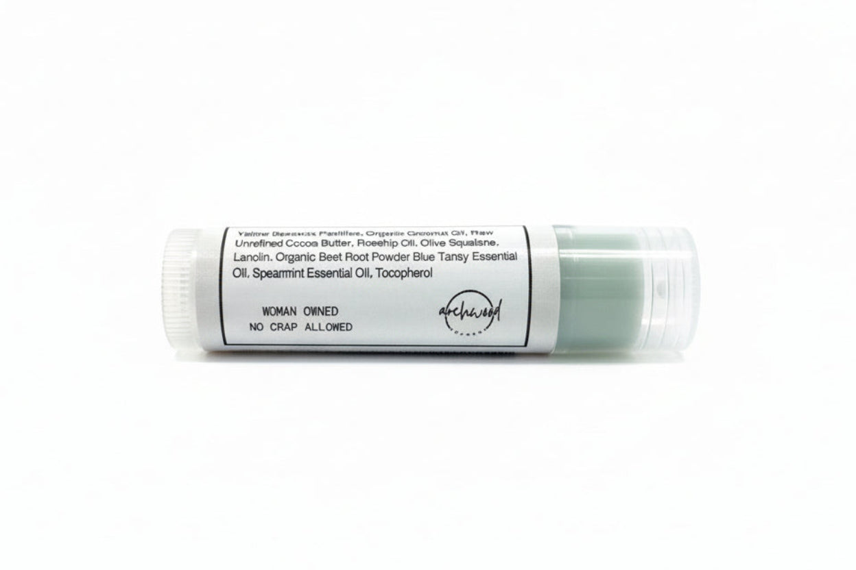 Lip balm stick with a label on a white background
