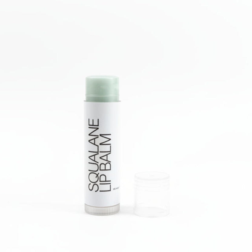 Lip balm with 'Squalane' text on a white background